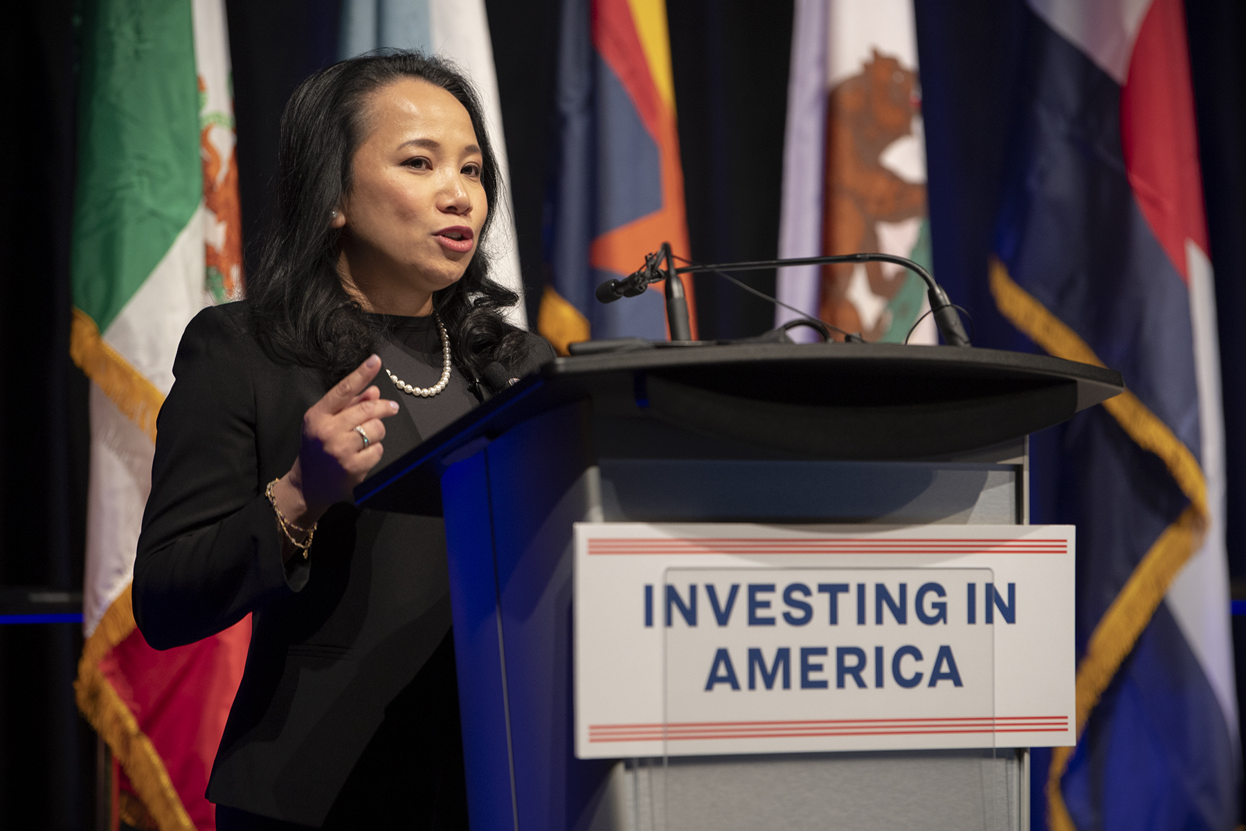 Commissioner Touton speaking at the Investing in America podium